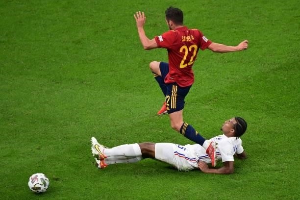 France's defender Jules Kounde tackles Spain's forward Pablo Sarabia during the Nations League final football match between Spain and France at San...