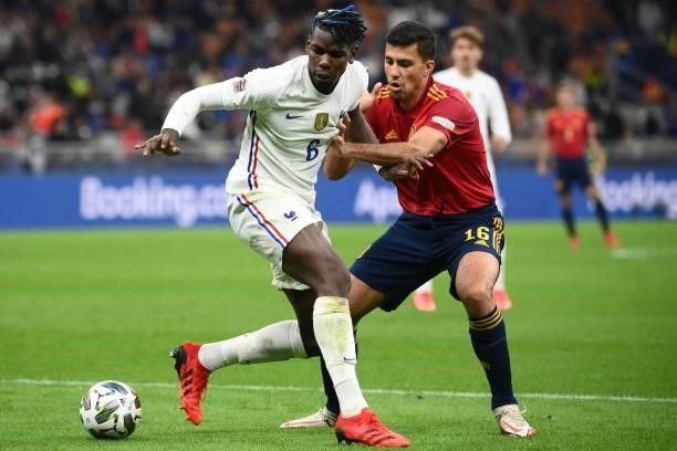 France's midfielder Paul Pogba vies with Spain's midfielder Rodri during the Nations League final football match between Spain and France at San Siro...