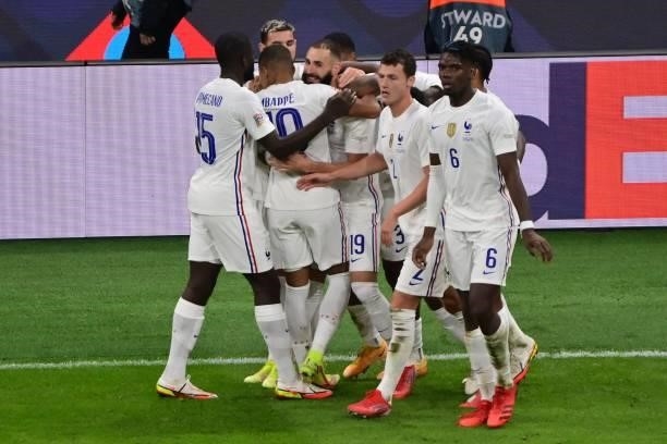 France's forward Karim Benzema celebrates with teammates after scoring a goal during the Nations League final football match between Spain and France...