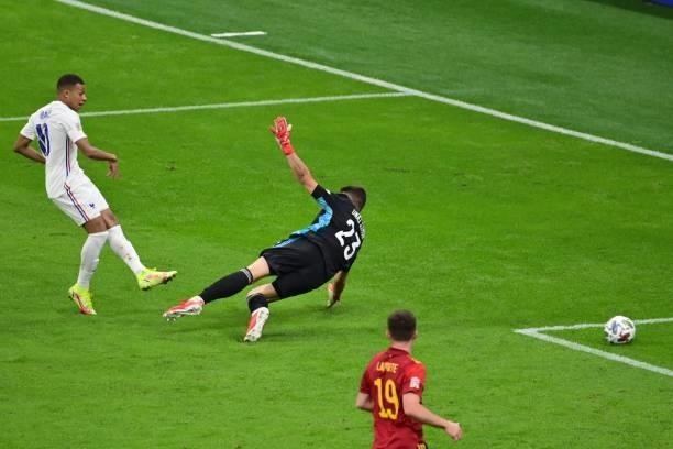 France's forward Kylian Mbappe scores a goal despite Spain's goalkeeper Unai Simon during the Nations League final football match between Spain and...
