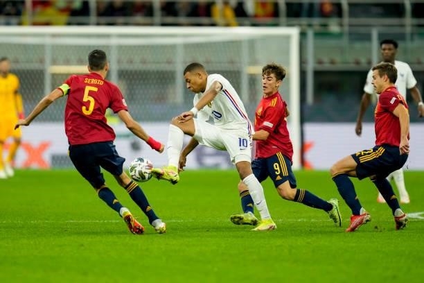 Sergio Busquets of Spain, Kylian Mbappe of France and Gavi of Spain battle for the ball during the UEFA Nations League Final match between the Spain...