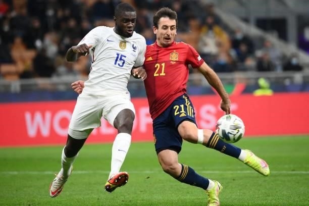 France's midfielder Dayot Upamecano vies with Spain's forward Mikel Oyarzabal during the Nations League final football match between Spain and France...