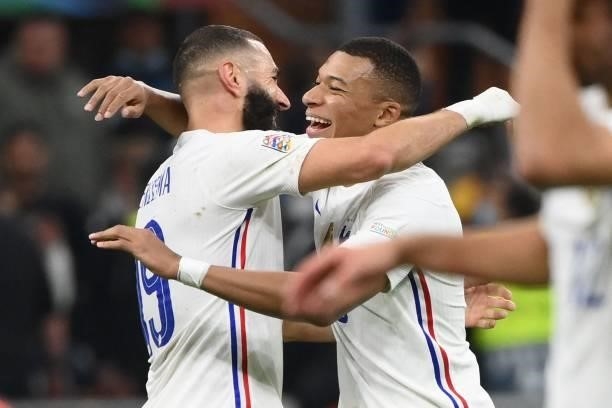 France's forward Karim Benzema and France's forward Kylian Mbappe celebrate their victory at the end of the Nations League final football match...