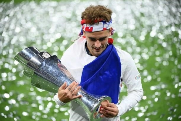 France's forward Antoine Griezmann celebrates with the trophy at the end of the Nations League final football match between Spain and France at San...