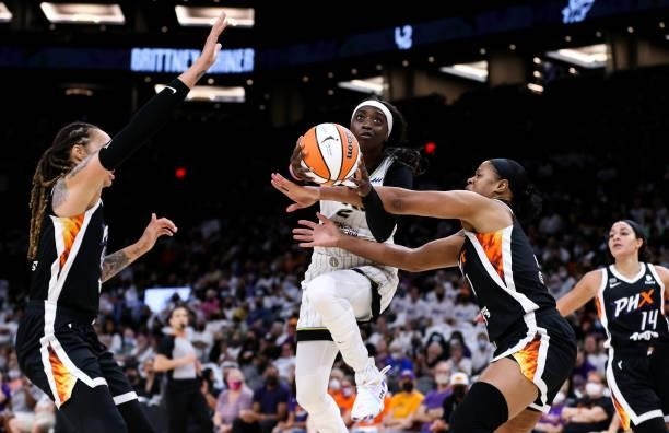 Kahleah Copper of the Chicago Sky drives to the basket against Brittney Griner and Kia Vaughn of the Phoenix Mercury in the second half at Footprint...