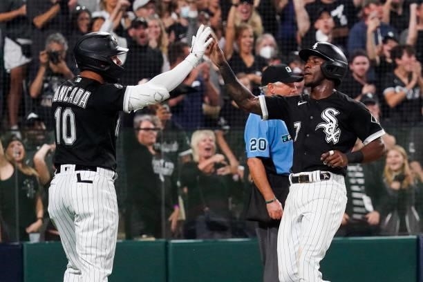 Tim Anderson of the Chicago White Sox celebrates with Yoan Moncada after scoring during Game 3 of the ALDS between the Houston Astros and the Chicago...