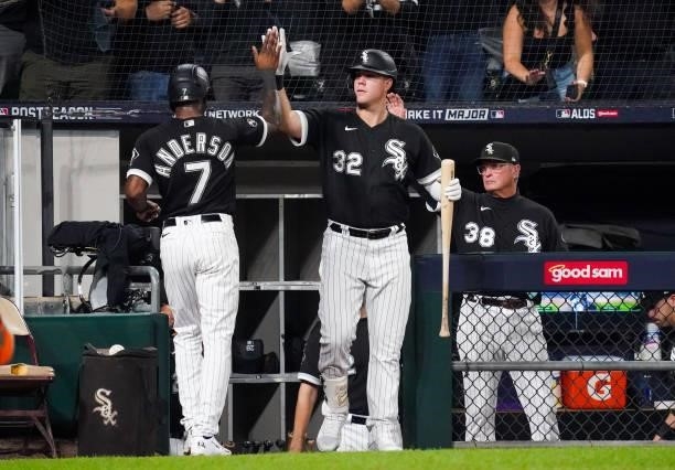 Tim Anderson of the Chicago White Sox celebrates with Gavin Sheets of the Chicago White Sox after scoring in the first inning during Game 3 of the...
