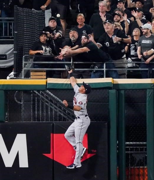Michael Brantley of the Houston Astros attempts to catch a home run off the bat of Yasmani Grandal of the Chicago White Sox in the third inning...