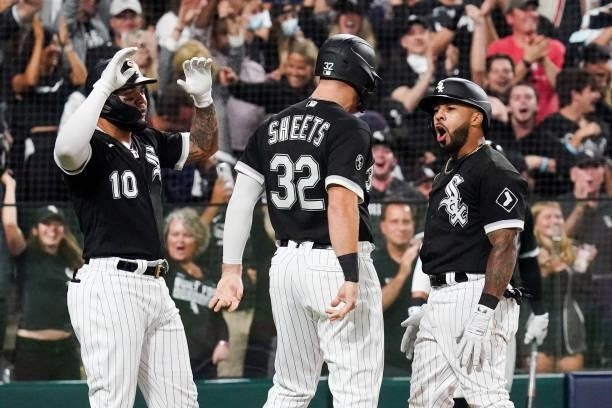 Leury Garcia of the Chicago White Sox celebrates with Gavin Sheets and Yoan Moncada after hitting a three run home run in the third inning during...