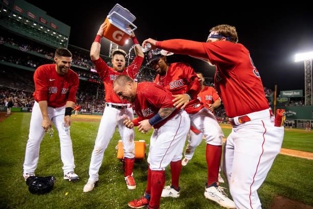 Christian Vazquez of the Boston Red Sox is doused with Gatorade after hitting a game winning walk-off two run home run during the thirteenth inning...
