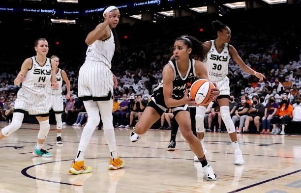 Skylar Diggins-Smith of the Phoenix Mercury drives past Azurá Stevens of the Chicago Sky, Candace Parker of the Chicago Sky and Allie Quigley of the...