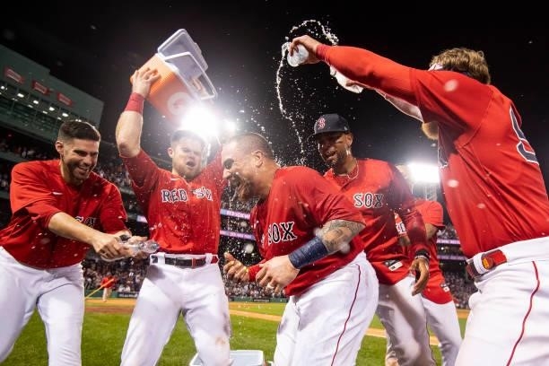 Christian Vazquez of the Boston Red Sox is doused with Gatorade after hitting a game winning walk-off two run home run during the thirteenth inning...