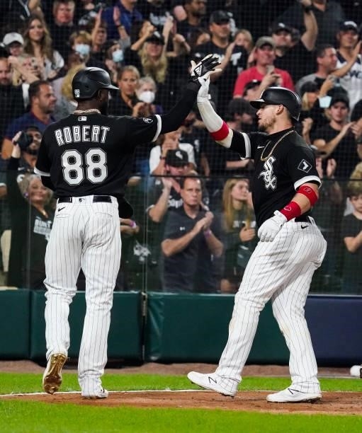 Yasmani Grandal of the Chicago White Sox celebrates with Luis Robert after hitting a two run home run in the third inning during Game 3 of the ALDS...