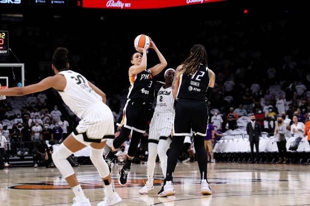 Diana Taurasi of the Phoenix Mercury shoots over Kahleah Copper of the Chicago Sky while screened by Brittney Griner of the Phoenix Mercury in the...