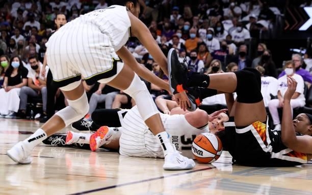 Dana Evans, Stefanie Dolson of the Chicago Sky and Diana Taurasi of the Phoenix Mercury fight over a loose ball in the second half at Footprint...