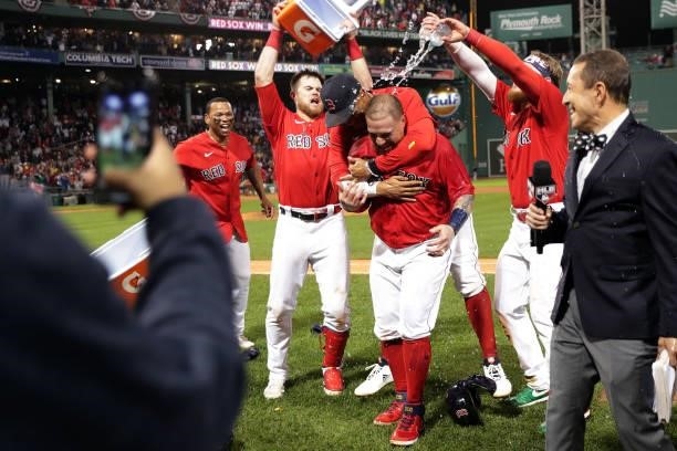 Christian Vázquez of the Boston Red Sox celebrates with teammates Rafael Devers, Christian Arroyo, Xander Bogaerts and Alex Verdugo after hitting a...