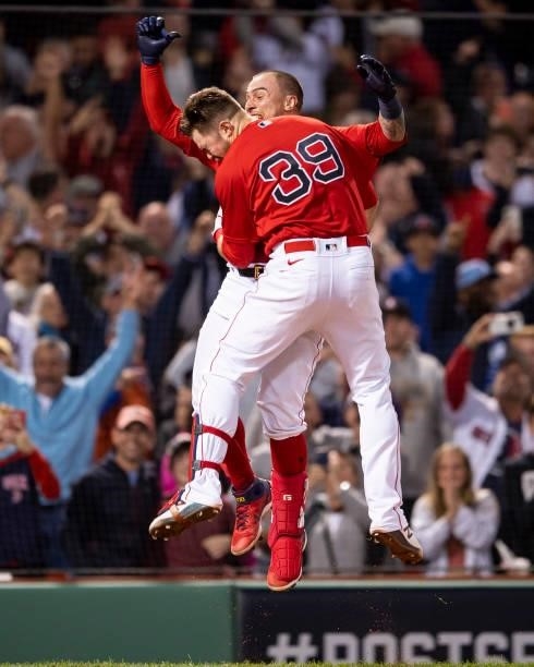 Christian Vazquez of the Boston Red Sox reacts with Christian Arroyo after hitting a game winning walk-off two run home run during the thirteenth...