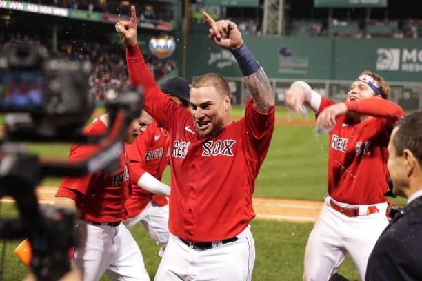 Christian Vázquez of the Boston Red Sox celebrates with teammates Christian Arroyo and Alex Verdugo after hitting a walk-off home run in the 13th...