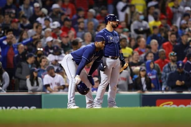 Yandy Díaz and Mike Zunino of the Tampa Bay Rays look on during a play review in the 13th inning during Game 3 of the ALDS between the Tampa Bay Rays...