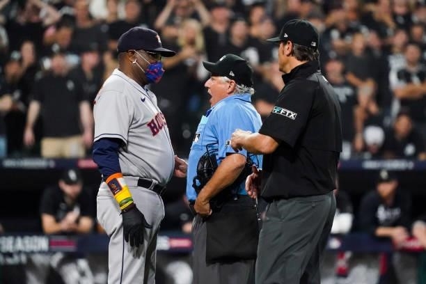Dusty Baker Jr. #12 of the Houston Astros argues with umpire Tom Hallion in the fourth inning during Game 3 of the ALDS between the Houston Astros...
