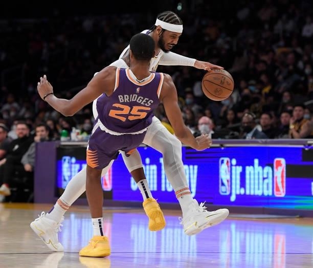 Mikal Bridges of the Phoenix Suns draws a charge from Carmelo Anthony of the Los Angeles Lakers in the first half of a preseason game at Staples...
