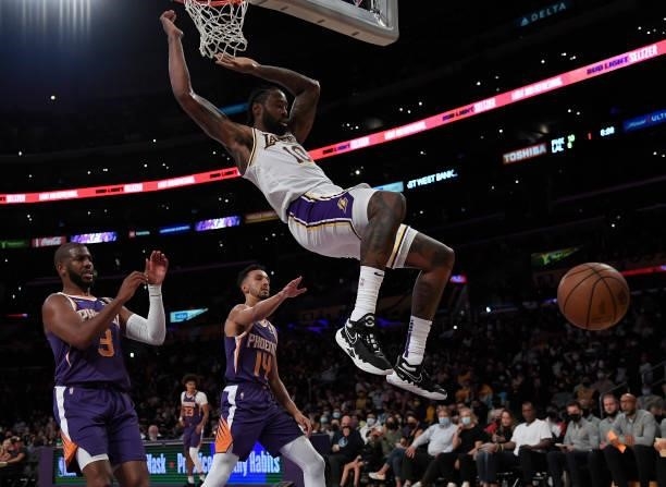 DeAndre Jordan of the Los Angeles Lakers dunks against Chris Paul of the Phoenix Suns in the first half of a preseason game at Staples Center on...
