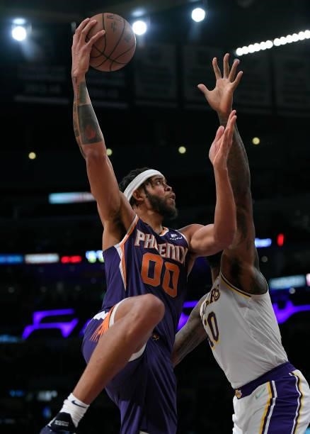 JaVale McGee Phoenix Suns shoots over DeAndre Jordan of the Los Angeles Lakers during the second half of a preseason game at Staples Center on...