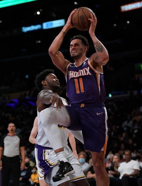 Abdel Nader of the Phoenix Suns is fouled by Cameron Oliver of the Los Angeles Lakers during the second half of a preseason game at Staples Center on...