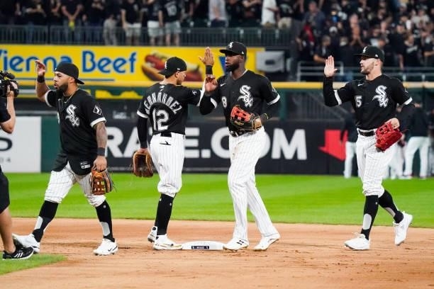 Members of the Chicago White Sox high five after the final out to defeat the Houston Astros 12-6 in Game 3 of the ALDS at Guaranteed Rate Field on...