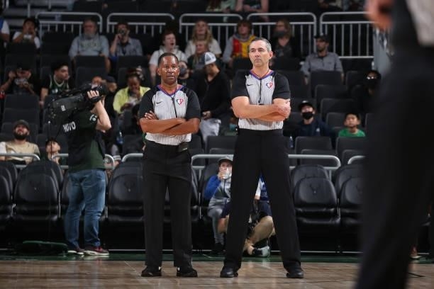 Referees, James Capers and Brett Nansel look on during a preseason game between the Milwaukee Bucks and the Oklahoma City Thunder on October 10, 2021...