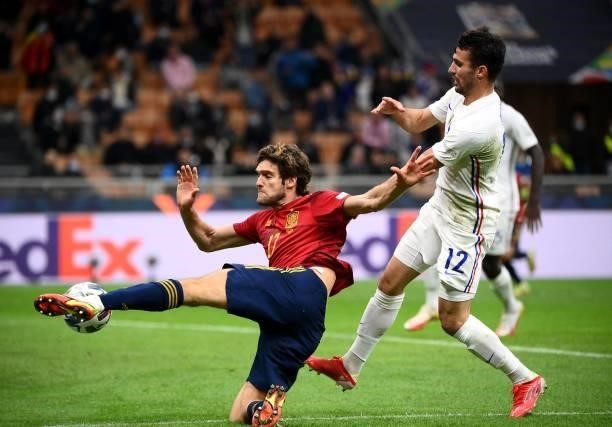 Spain's forward Mikel Oyarzabal kicks the ball next to France's defender Leo Dubois during the Nations League final football match between Spain and...
