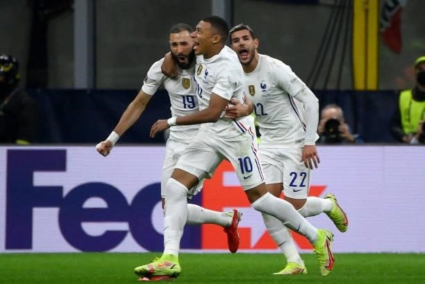 France's forward Karim Benzema is congratulated by France's forward Kylian Mbappe and Fance's defender Theo Hernandez after scoring a goal during the...