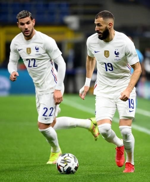 France's forward Karim Benzema plays the ball nex to Fance's defender Theo Hernandez during the Nations League final football match between Spain and...