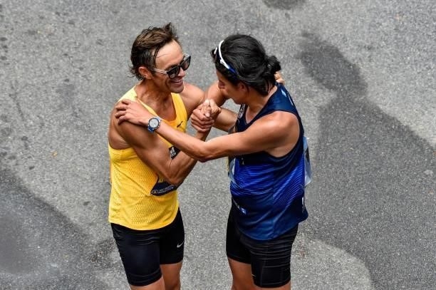 Blue Benadum and Luis Carlos Rivero embrace at the finish line after finishing the race during the 125th Boston Marathon in Boston, Massachusetts on...