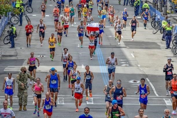 Runners make their way to the finish line down Boylston Street during the 125th Boston Marathon in Boston, Massachusetts on October 11, 2021.
