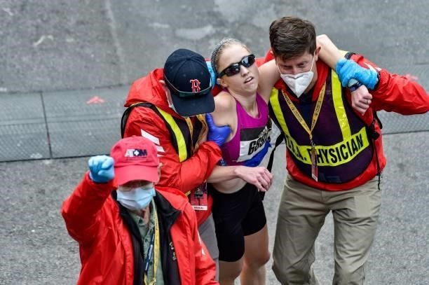 Runner collapses as she runs down Boylston Street and is aided by medics during the 125th Boston Marathon in Boston, Massachusetts on October 11,...