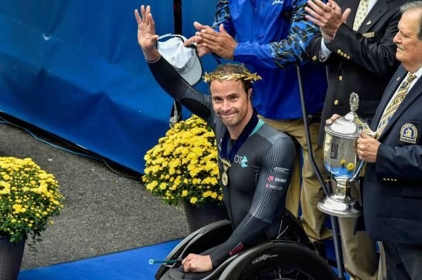 Switzerlands Marcel Hug waves after taking first place in the mens wheelchair division during the 125th Boston Marathon in Boston, Massachusetts on...