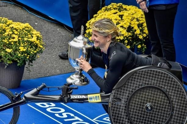 Switzerland's Manuela Schar is honored with a trophy for taking first place in the women's wheelchair division during the 125th Boston Marathon in...