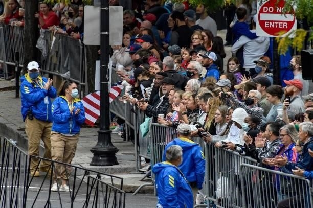 Fans cheer on runners during the 125th Boston Marathon in Boston, Massachusetts on October 11, 2021.