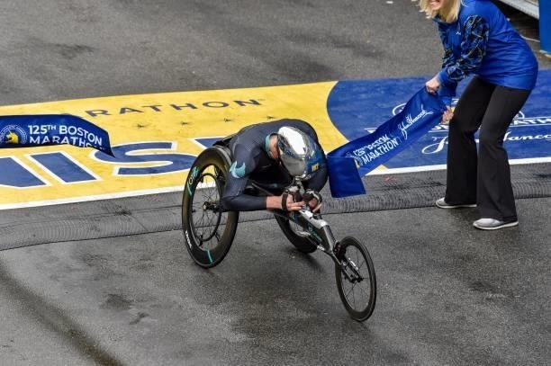 Switzerland's Marcel Hug crosses the finish line on Boylston Street and takes first place in the menÕs wheelchair division during the 125th Boston...