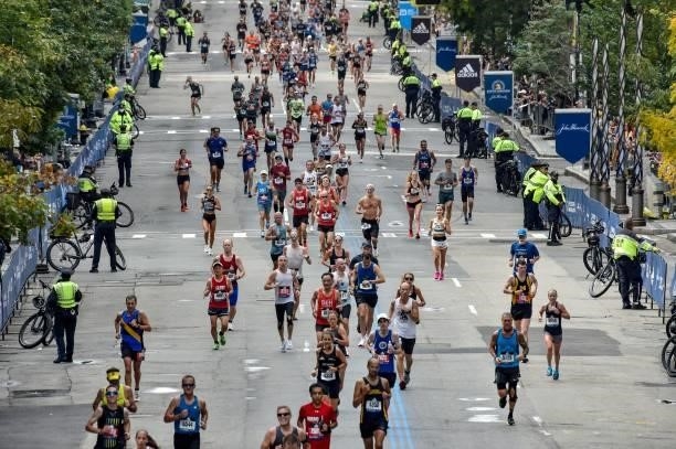 Runners make their way to the finish line down Boylston Street during the 125th Boston Marathon in Boston, Massachusetts on October 11, 2021.