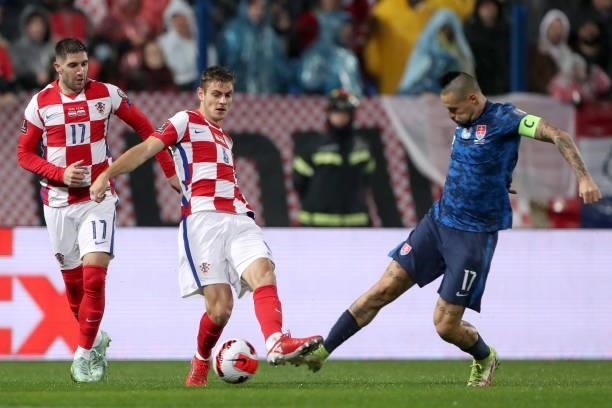 Josip Stanisic of Croatia in action against Marek Hamsik of Slovakia during the 2022 FIFA World Cup Group H Qualifier match between Croatia and...