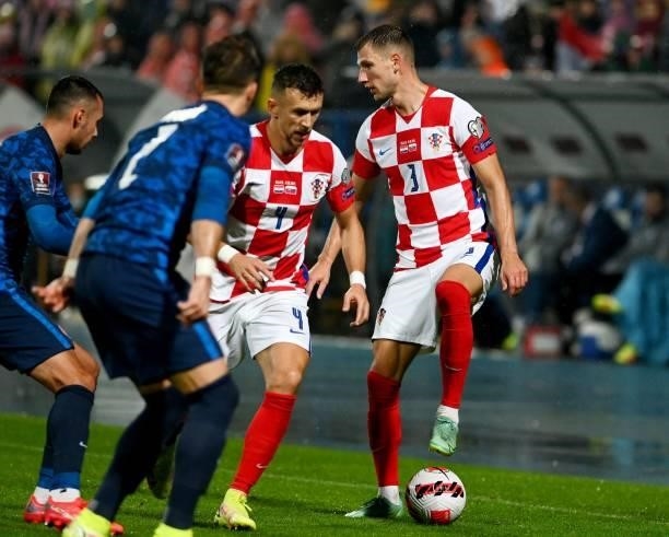Croatia's Defender Borna Barisic and forward Ivan Perisic fight for the ball with Slovakia's defender Peter Pekarik during the FIFA World Cup Qatar...