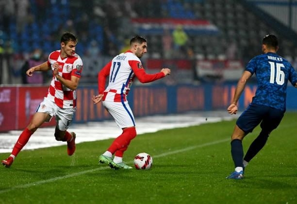 Croatia's midfielder Luka Ivanusec and midfielder Josip Stanisic fight for the ball with with Slovakia's defender David Hancko during the FIFA World...