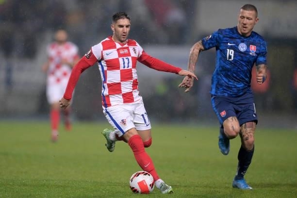 Luka Ivanusec of Croatia and Juraj Kucka of Slovakia in action during the 2022 FIFA World Cup Group H Qualifier match between Croatia and Slovakia at...