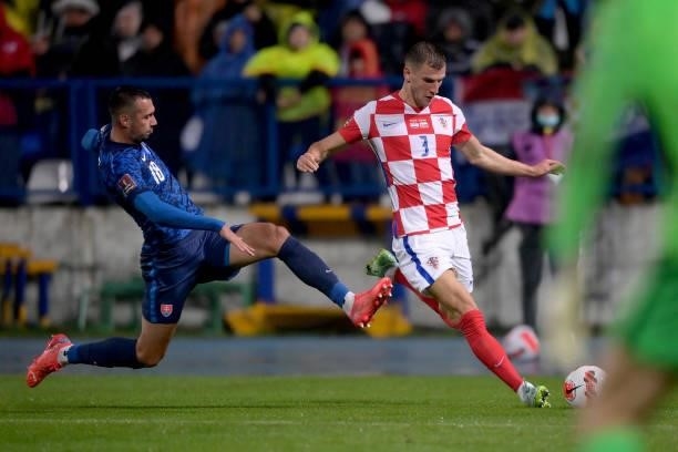 Borna Barisic of Croatia in action against Ivan Schranz of Slovakia during the 2022 FIFA World Cup Group H Qualifier match between Croatia and...