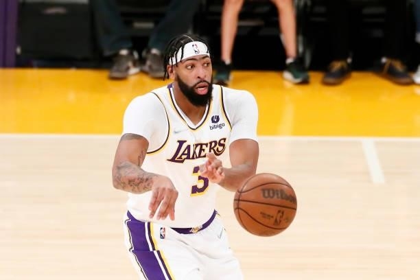 Anthony Davis of the Los Angeles Lakers looks to pass the ball during a preseason game against the Phoenix Suns on October 10, 2021 at STAPLES Center...