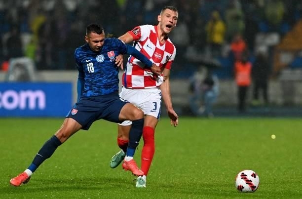 Croatia's defender Borna Barisic vies with Slovakia's defender David Hancko during the FIFA World Cup Qatar 2022 qualification Group H football match...
