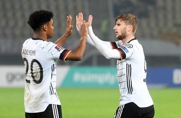 Germany's Timo Werner celebrates with teammate Karim Adeuemi after scoring during the FIFA World Cup Qatar 2022 qualification Group J football match...