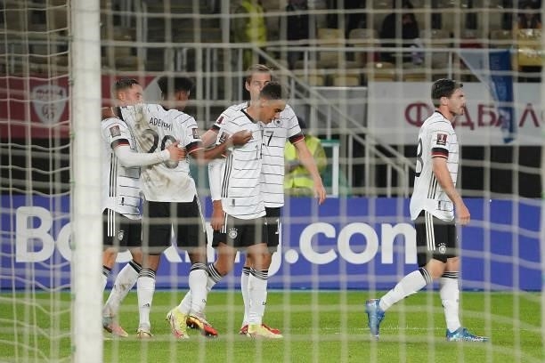 Jamal Musiala of Germany celebrates after scoring his team's fourth goal with teammates during the 2022 FIFA World Cup Qualifier match between North...